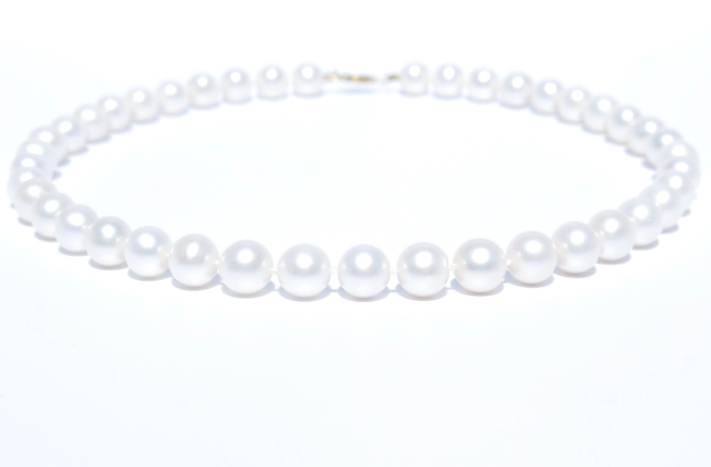 This pearl jewelry is a work of art and each pearl is hand-picked and matched in Guelph, Ontario, Canada. This elegant and gorgeous white pearl necklace is handmade with 100% cultured freshwater pearls, 18K white gold and silk thread. Pearl Size: 9.5-10.5 mm; Pearl Strand Length: 46 cm. 